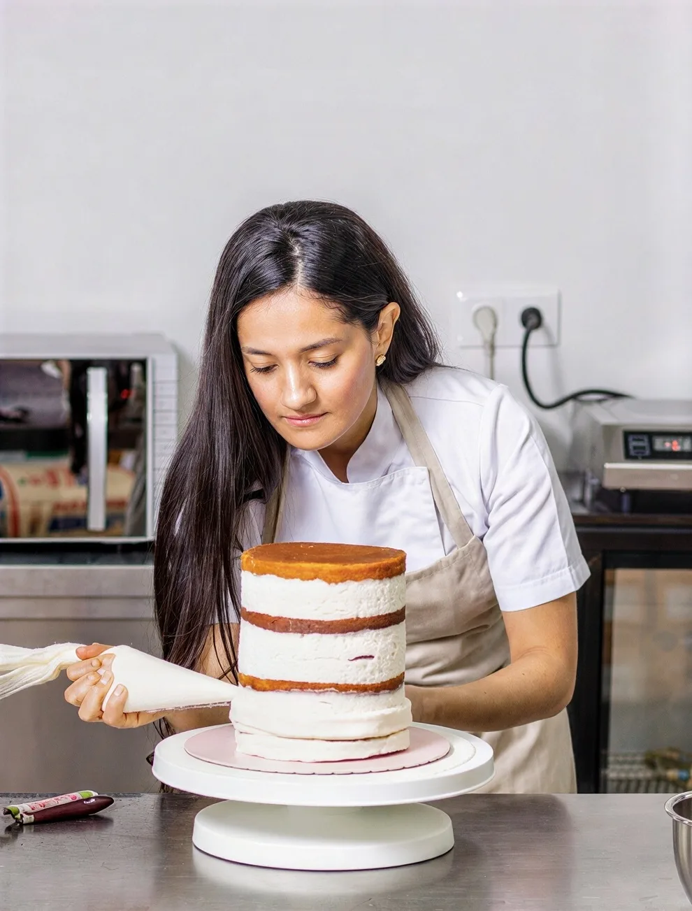A woman decorating a cake